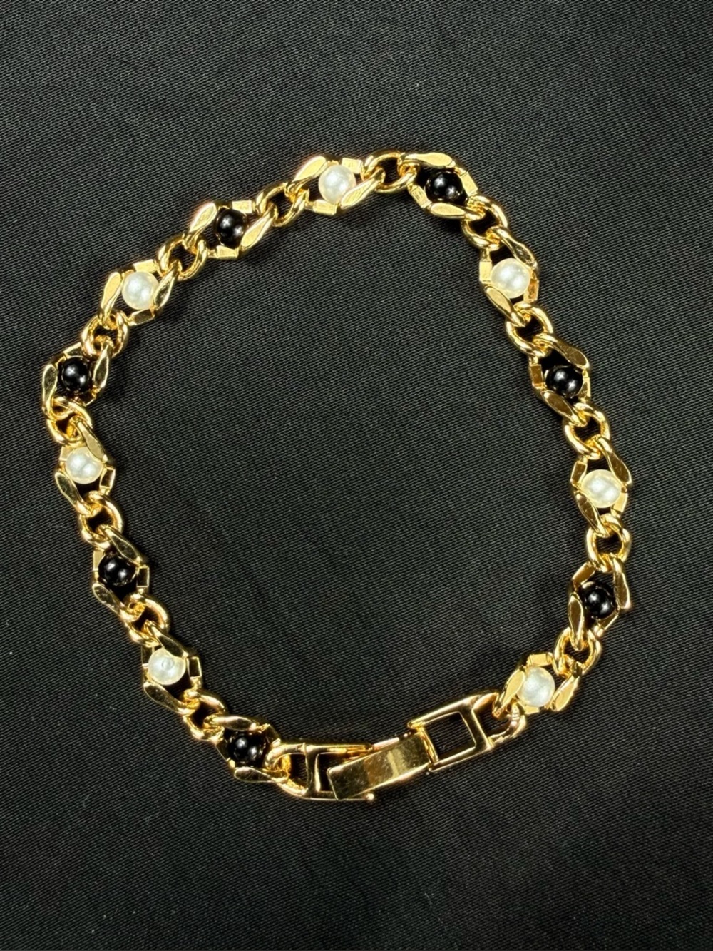 Vintage Gold tone bracelet with white and black beads.